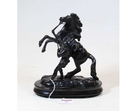 A black painted spelter model of a Marly Horse, mounted on an ebonised plinth, h.24cm