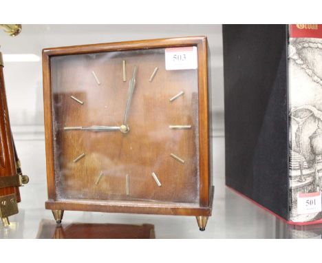 A 1960s Smiths walnut cased mantel clock of square form having raised baton markers and eight day movement striking on a gong