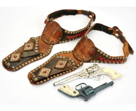 Pair of wild west Apache and Lone Star cowboy revolver guns, each within Wild Bill Hickock leather gun holsters, some surface