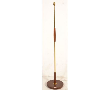 A vintage retro 20th Century teak and brass column standard lamp raised on a circular teak base. Measures 142 cm tall x 42 cm