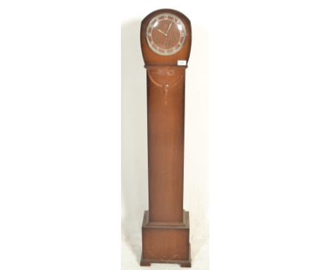 An early 20th Century panel oak cased grandmother clock having applied metal Arabic numeral chapter ring.&nbsp;Raised on a pl