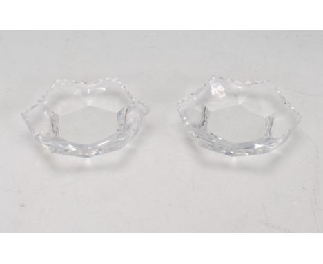 A pair of Lalique glass night light / tea light holders of hexagonal form having faceted sides and edges. Both signed Lalique