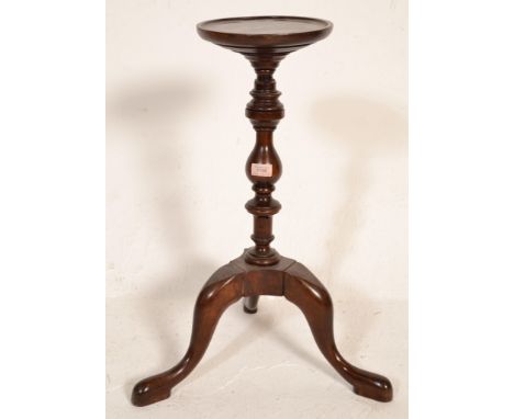 A 19th Century mahogany plant torchere / kettle stand raised on a tripod base with turned central column with round lipped st
