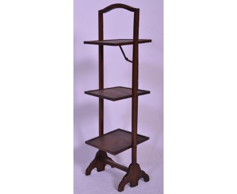 A vintage early 20th Century 1930's oak three tier folding cake stand of square form raised on scroll supports with carrying 