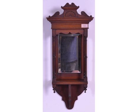 A 19th Century Victorian mahogany wall hanging hall mirror of rectangular form. The mirror having a carved mahogany arched pe