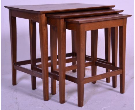 A vintage 20th Century nest of three table having rectangular tops raised on tapering block legs united by stretchers. Measur