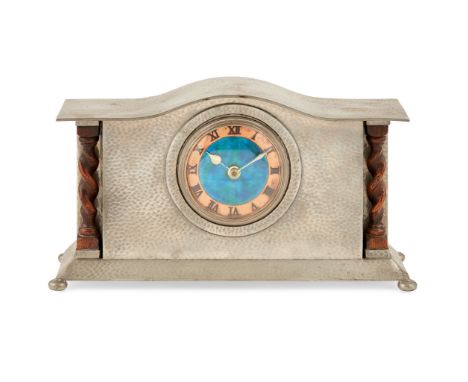 LIBERTY &amp; CO., LONDON MANTEL CLOCK, CIRCA 1920 hammered pewter with copper and enamel dial and oak pilasters, fitted with