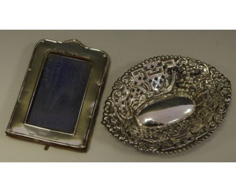 A silver oval pin dish; a silver easel frame (2)