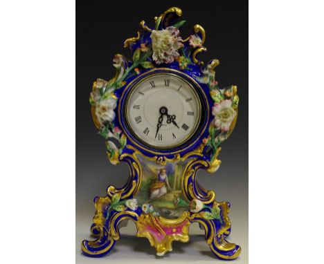 A porcelain mantel clock profusely decorated with colourful flora on cobalt ground. 