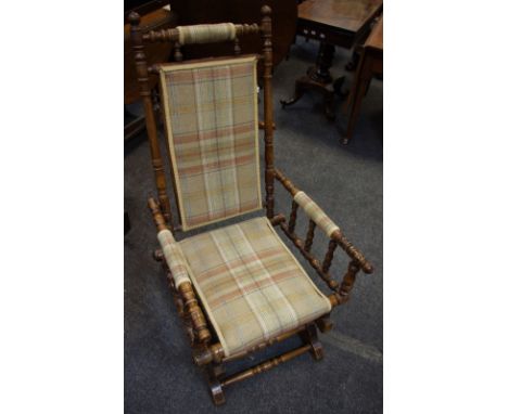 A 19th century American rocking chair, bobbin turned supports, tweed upholstery