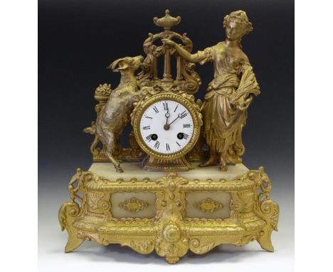 A 19th century gilt metal figural mantel clock, spelter figure of girl and goat, enamelled dial, Roman numerals.