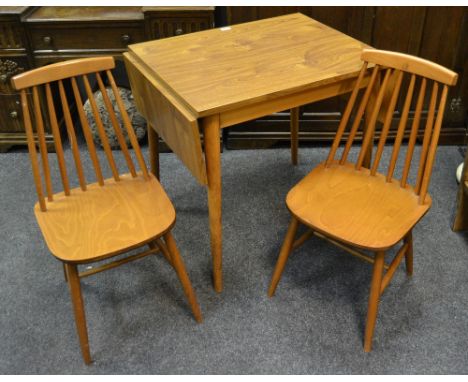 A retro drop leaf kitchenette table, tapering cylindrical legs; two Ercol type spindle back chairs (3)