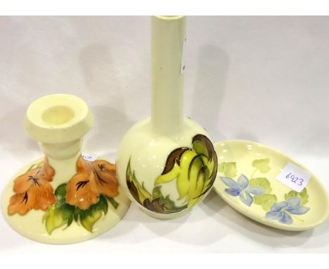 Moorcroft bottle vase, H: 16 cm, Moorcroft candlestick, H: 90mm and an oval pin dish, L: 12 cm, all with light crazing otherw