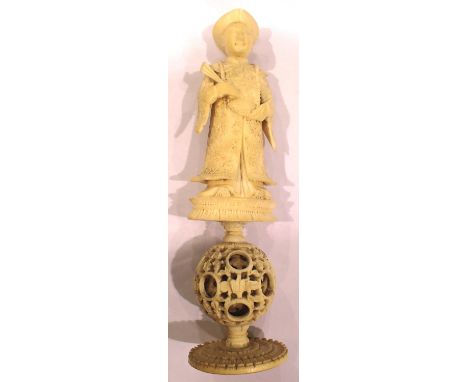 Hand carved ivory figurine on plinth with puzzle ball below, H: 15 cm. P&amp;P Group 1 (£14+VAT for the first lot and £1+VAT 