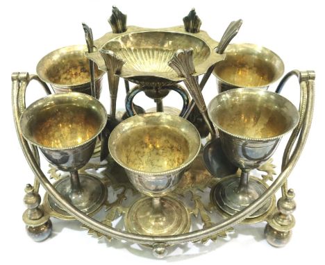 Set of six silver plated egg cups and spoons on an ornate stand, L: 20 cm. P&amp;P Group 2 (£18+VAT for the first lot and £3+