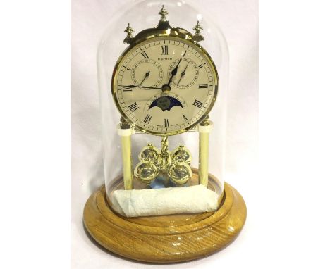 Modern Hermle anniversary clock with day and date dials and moon phase, beneath glass dome, H: 21 cm. P&amp;P Group 3 (£25+VA