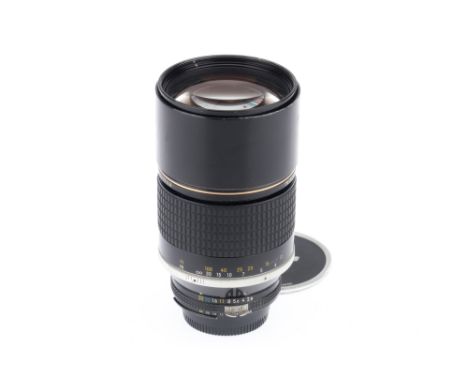 A Nikon Nikkor *ED f/2.8 180mm Lens, black, barrel G, serial number 381744, optics F-G, light marks to front element, with ca