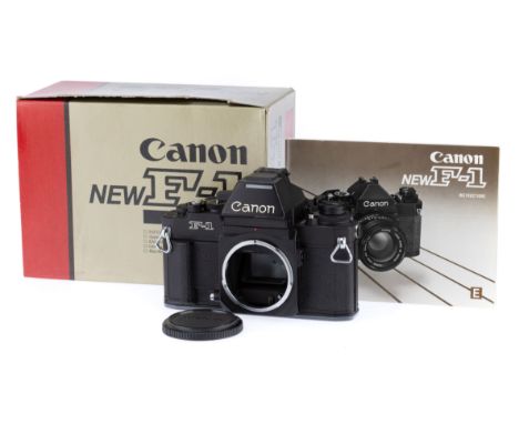 A Canon New F1 35mm SLR Camera Body, black, serial number 216285, body VG-E, appears to be very lightly used, very small pain