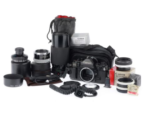 A Canon A-1 35mm SLR Camera and Accessories, black, serial number 570905, body VG, shutter works, meter responds to light, wi