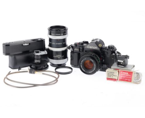 A Canon A-1 35mm SLR Camera and Accessories, black, serial number 1731550, body G, brassing to bottom plate, shutter works, m