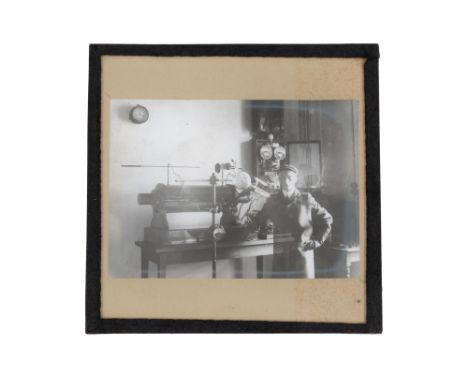 Early X-Ray Related Magic Lantern Slide, the lantern slide showing a radiologist, with lead apron and protective gloves stand