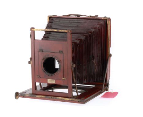 A Watson 8x10 Inch Studio Camera, English, of mahogany and brass construction with strong brass bindings, opens and folds cor