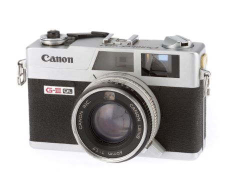 A Canon Canonet QL17 G-III QL Camera, silver, body G, shutter works, iris works, optics F-G with light haze.
