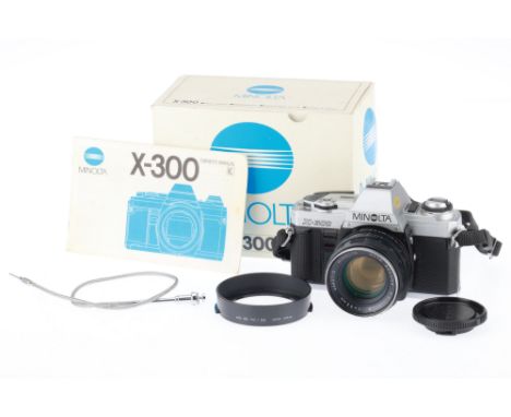 A Minolta X-300 35mm SLR Camera, silver, serial number 9202234, body G, battery compartment has evidence of leakage, not powe