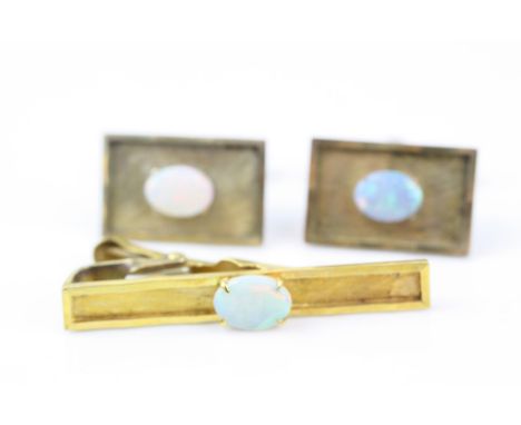 Pair of opal 18ct yellow gold cufflinks, the textured rectangular panel set with oval cabochon cut precious white opal, displ