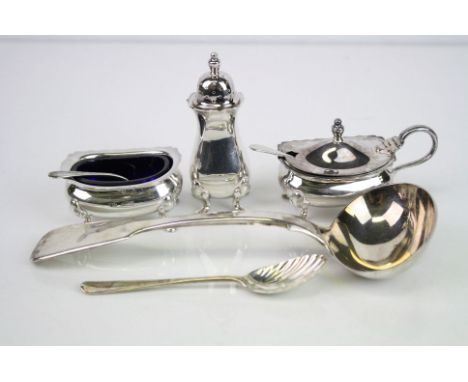 Matched three piece silver cruet, comprising open salt cellar, pepper pot, mustard pot, blue glass liners, each raised on fou