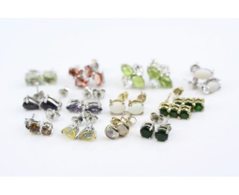 Twelve pairs of gem set silver stud earrings, to include precious white opal, fire opal, labradorite, tanzanite, chrome diops