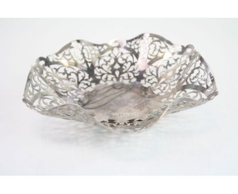 Silver pierced bon bon dish, raised on three bun feet, pierced foliate scroll handkerchief design, makers Da-Mar Silverware, 