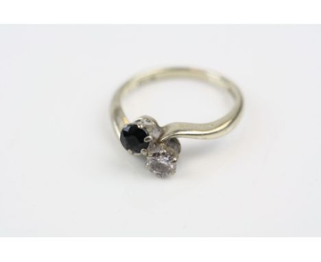 Diamond and sapphire 18ct white gold crossover ring, round mixed cut blue-black sapphire, round brilliant cut diamond, diamon