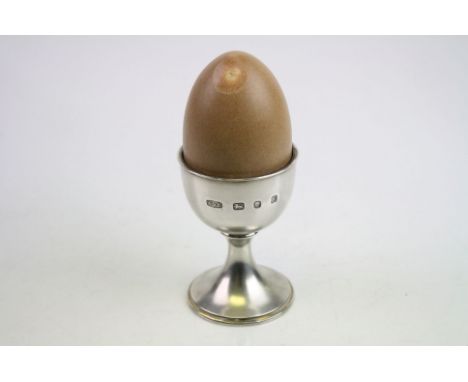 Novelty silver musical egg timer modelled as an egg and egg cup, (the realistic shell should remove to reveal figures but the