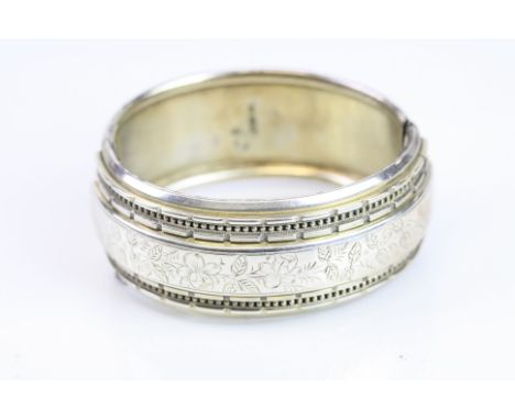 Victorian silver hinged bangle, engraved floral and foliate design to the centre, with repeating rectangular steps, rope twis