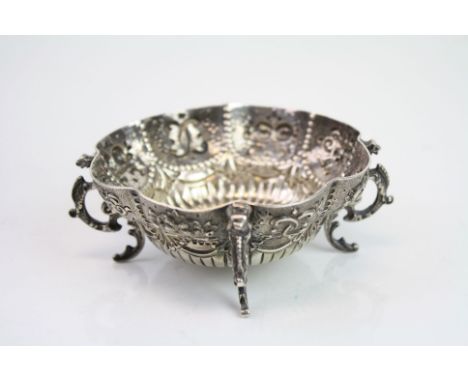 Victorian silver trinket dish raised on four scroll feet, repousse mask, berry and scroll design to body, makers Holland, Ald