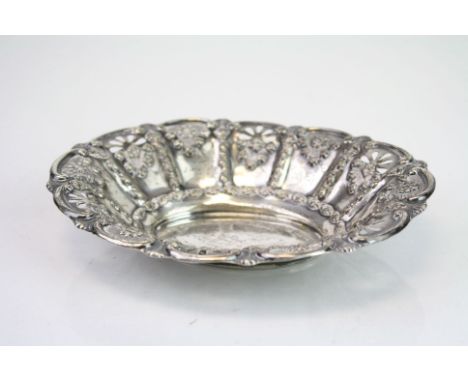 Edwardian silver oval trinket dish, repousse floral and scroll decoration to body, pierced sun burst design, makers Goldsmith