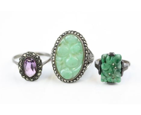 Three silver rings comprising circa 1920s jade ring, a jade and marcasite dress ring, together with a circa 1930s amethyst an