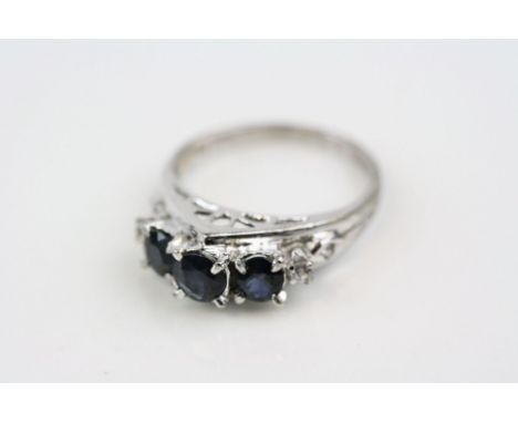 Sapphire and diamond 14ct white gold ring, three round greenish-blue sapphire, four claw settings, a small round brilliant cu