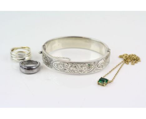 Silver hinged bangle, engraved floral and leaf design to upper half, makers Bravingtons Ltd, Birmingham 1937 together with a 