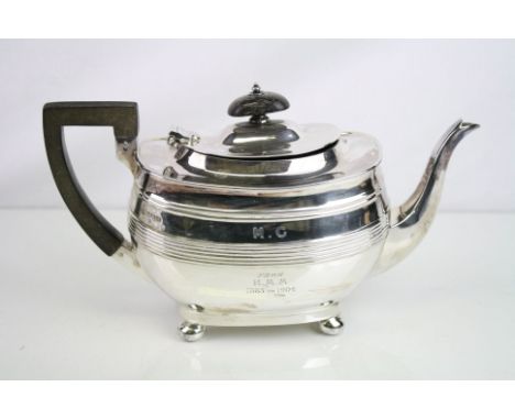 Edwardian three piece silver tea service comprising teapot, milk jug and twin handled sugar bowl, each raised on four bun fee