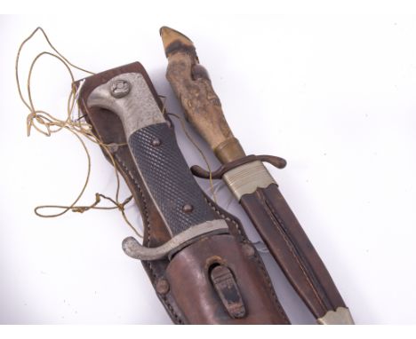 German bayonet, metal scabbard and leather frog and a deer's foot dirk, (2).