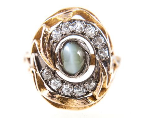 Tom Payne and Peter Triggs - A chrysoberyl cats eye and diamond dress ring, the oval cabochon cut cats eye 6.5mm x 5mm, colle