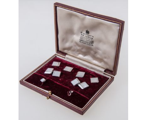 A cased part set of 9 carat white gold dress studs, comprising a pair of cufflinks, four buttons and one stud, square three d