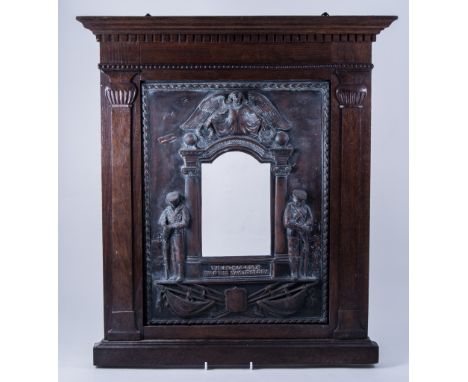 A WWI memorial frame, embossed metal inset with arched aperture surrounded by architectural Ionic columns, angel pediment and