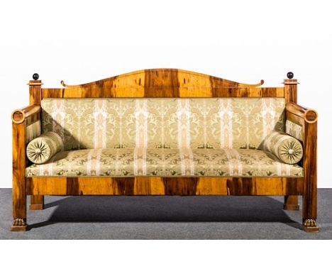 Biedermeier style lignum vitae sofa, upholstered in cotton brocade, arched back, vertical ends, deep frieze, lion paw feet, l