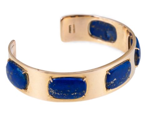 A 14 carat yellow gold and lapis lazuli bangle, five rectangular lapis lazuli  graduating from 15mm x 9mm, individually four 