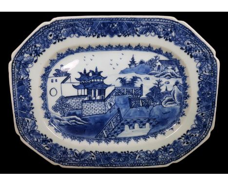 A Chinese export porcelain blue and white meat plate, of rounded rectangular form, decorated with a scene of a pagoda with br