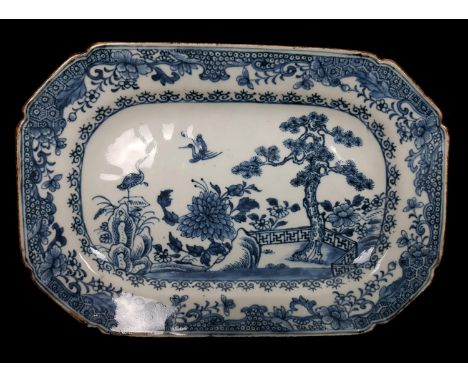 A Chinese export porcelain blue and white meat plate, of shaped rectangular form, painted with cranes in a garden setting wit