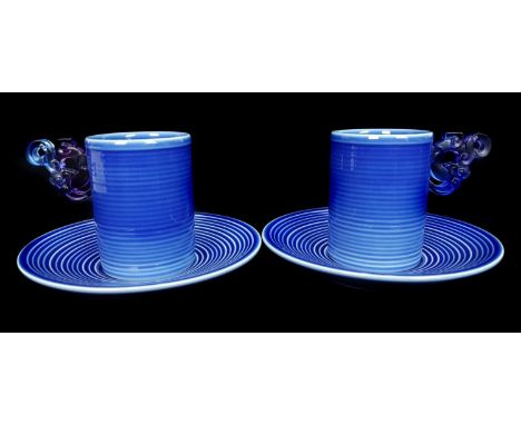 Loretta Hui-shan Yang or Yang Huishan - two ribbed and blue glazed porcelain cups and saucers, the cups of beaker form with c